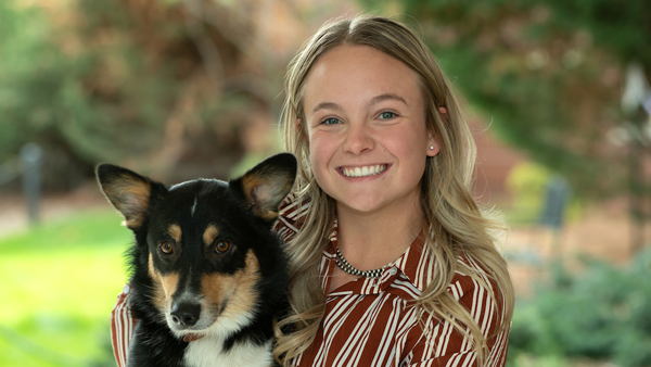Jordan with her dog Rooster, outside the Veterinary Teaching Hospital.
