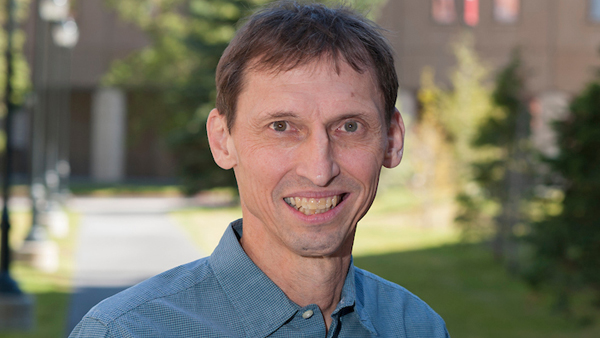 Dr. Michael Varnum outside the College on a sunny day.