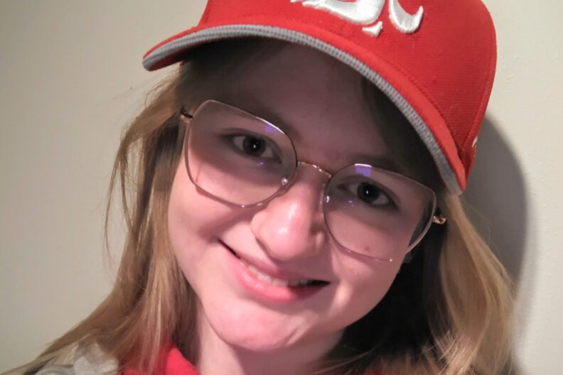 Up close photo of Emily, wearing a Coug hat.