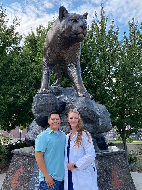Cole and his wife Siena in front of the Cougar statue on Stadium Way in Pullman.