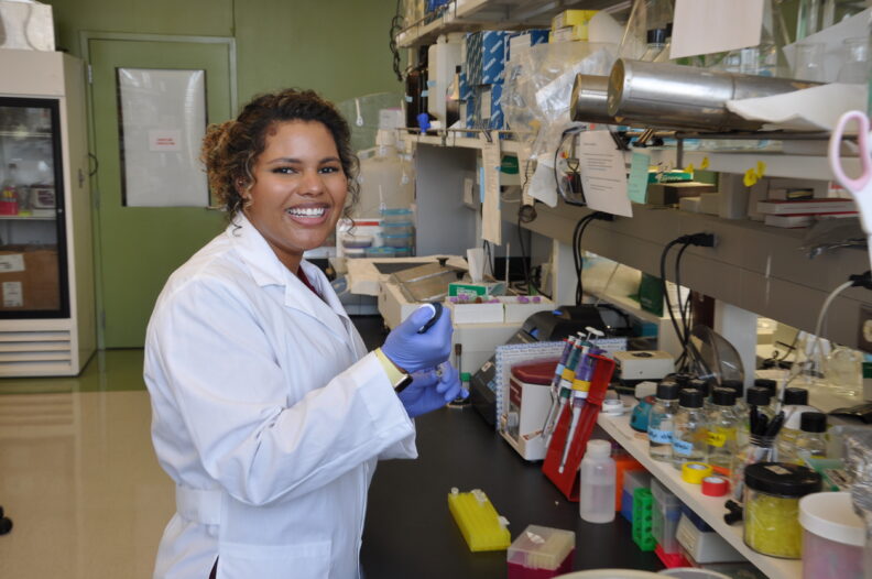 Graduate student Bri Jones works in a lab.