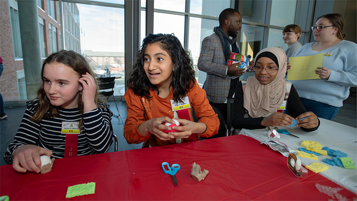 Three young girls enjoying at activity during the 2024 Kids Judge! event at WSU Pullman.