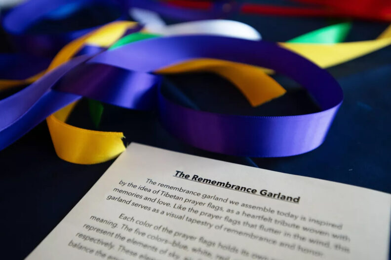 Close up photo of Remembrance Garlands, and a paper explaining the purpose of the garland.