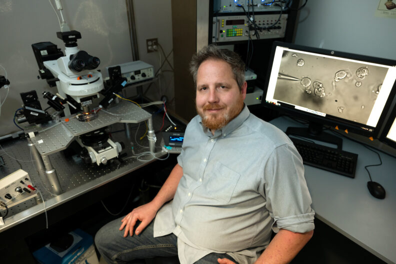 James Peters, an associate professor in the integrative physiology and neuroscience department in Washington State University's College of Veterinary Medicine, poses for a photo in his lab.