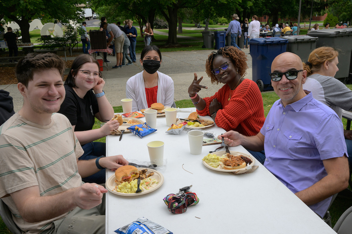 Five people at the table with their meals.