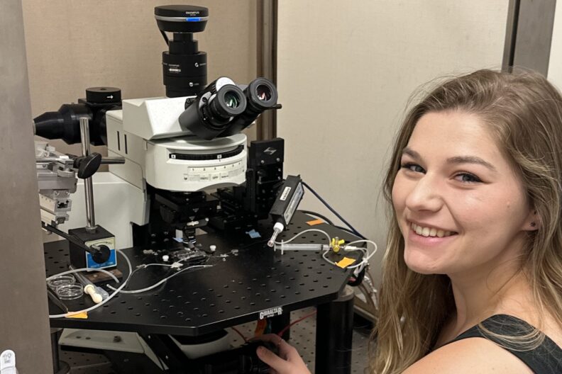 Meg Southard at a microscope.