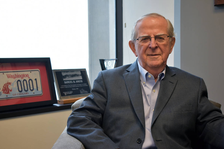 Sam sitting at his desk.