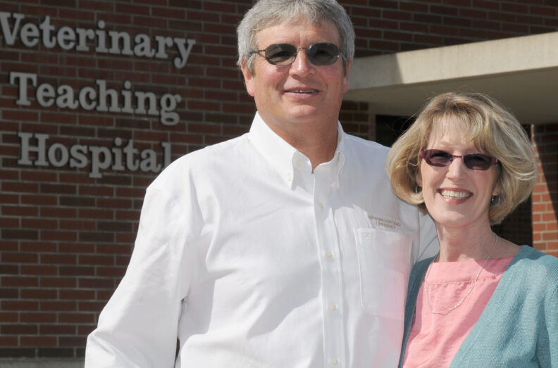 Mike and Sue Wedam standing in front of the Veterinary Teaching Hospital.