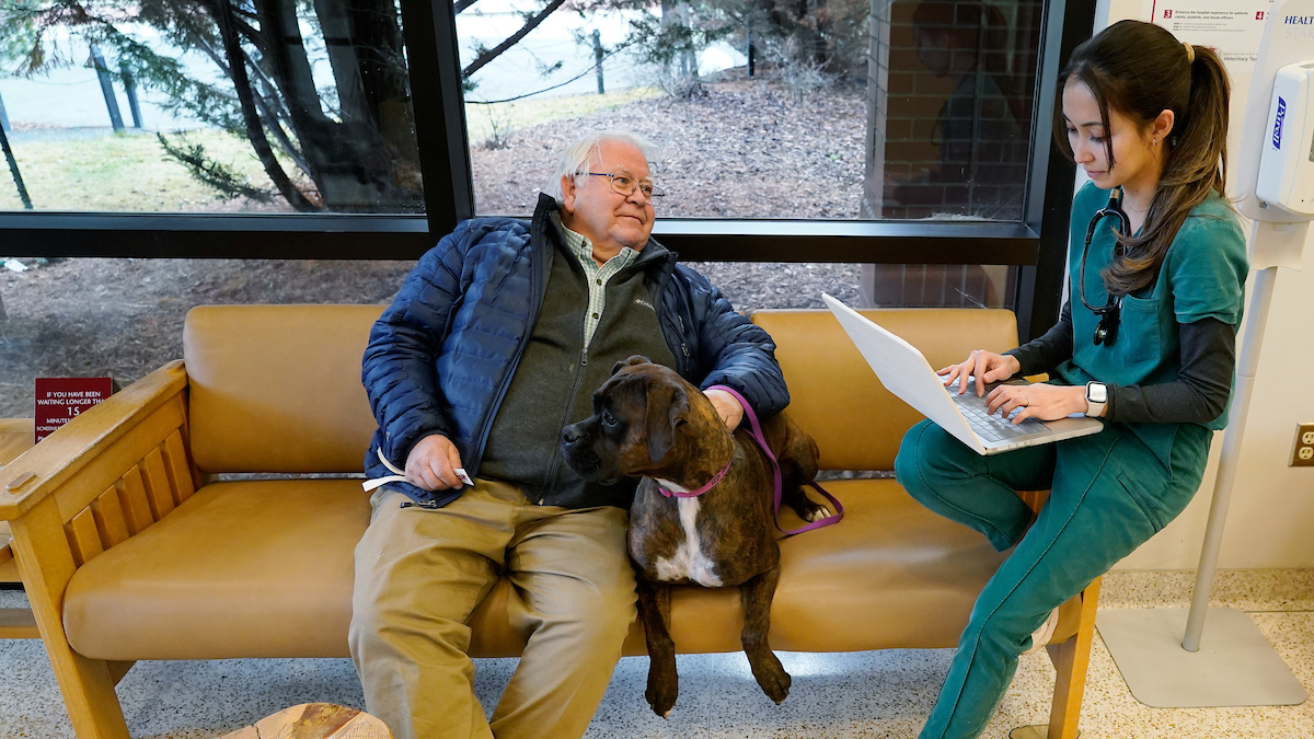 Vet student in lobby with client
