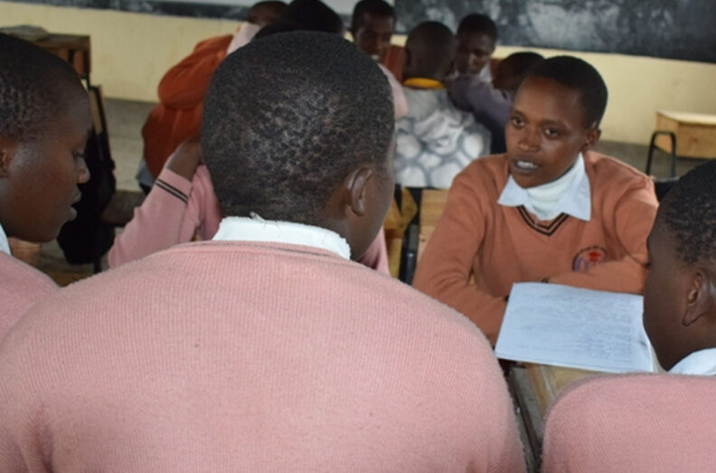 Terryann in a classroom with other students.