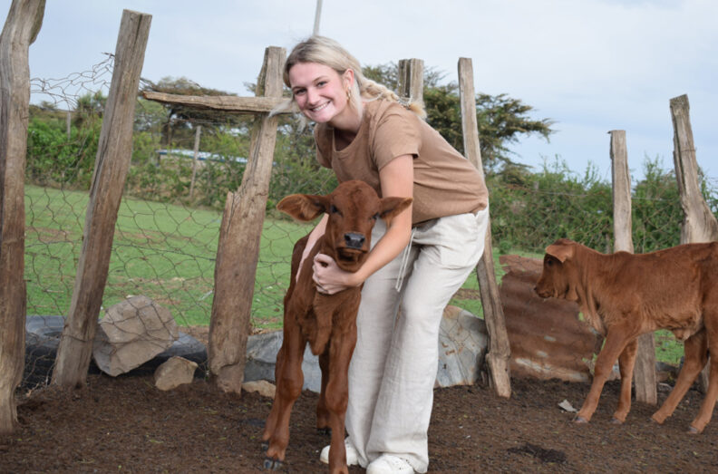 Josie embracing a calf.