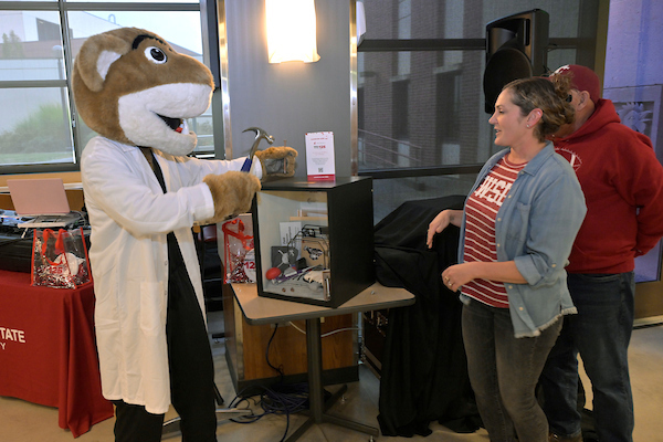 Butch pretending to nail shut the time capsule.