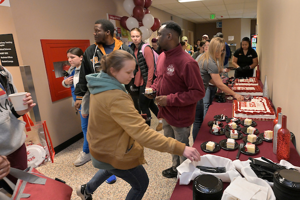 The hustle and bustle in the hallway where the 125 cake was being served.
