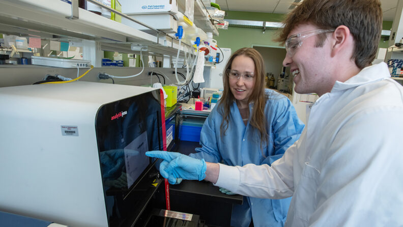Heather Koehler with student in lab.