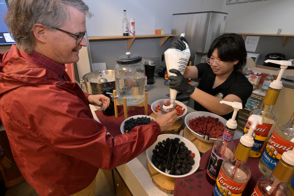 Phil Mixter on the left getting whip cream added to the top of his Italian soda.