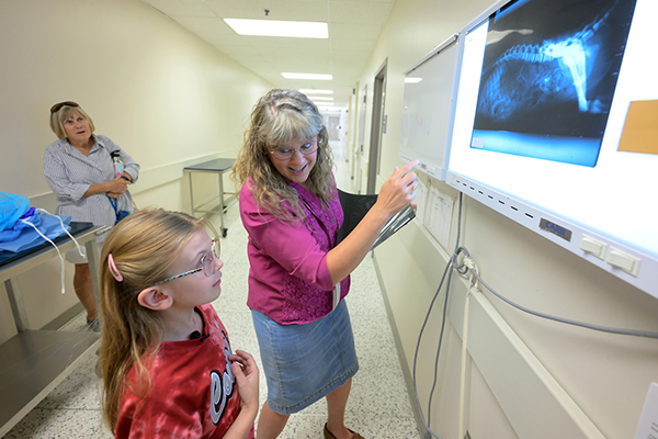 Maddie Hedrick views an X-ray with Raelynn Farnsworth.