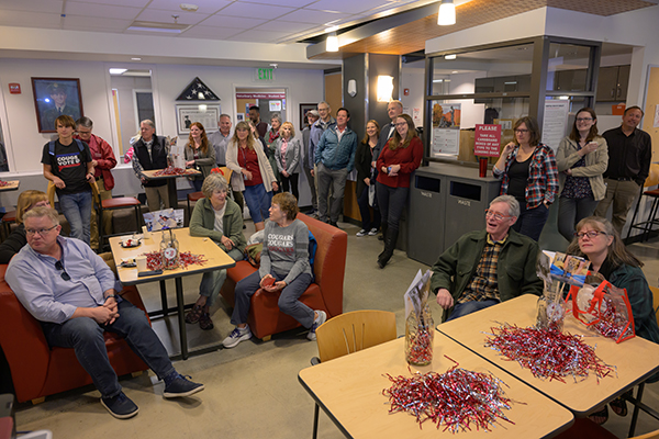 Crowd, seated and standing, in the Mickelsen Lounge during the 125 celebration.