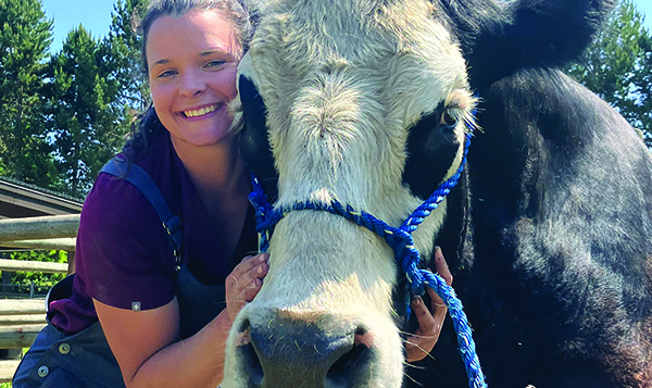 Dr. Marre posing with a cow.