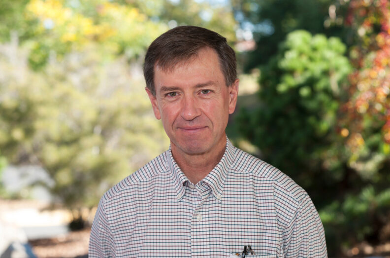 Rance Sellon outside the college on a sunny day in summer.