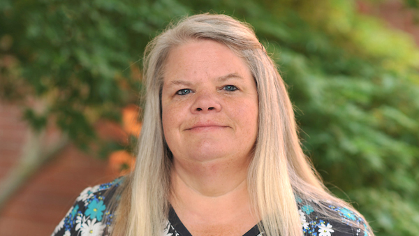 Denise outside the Teaching Hospital on a summer day.