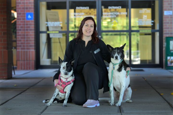 Lori Tierney with her dogs at the main entrance to the VTH.