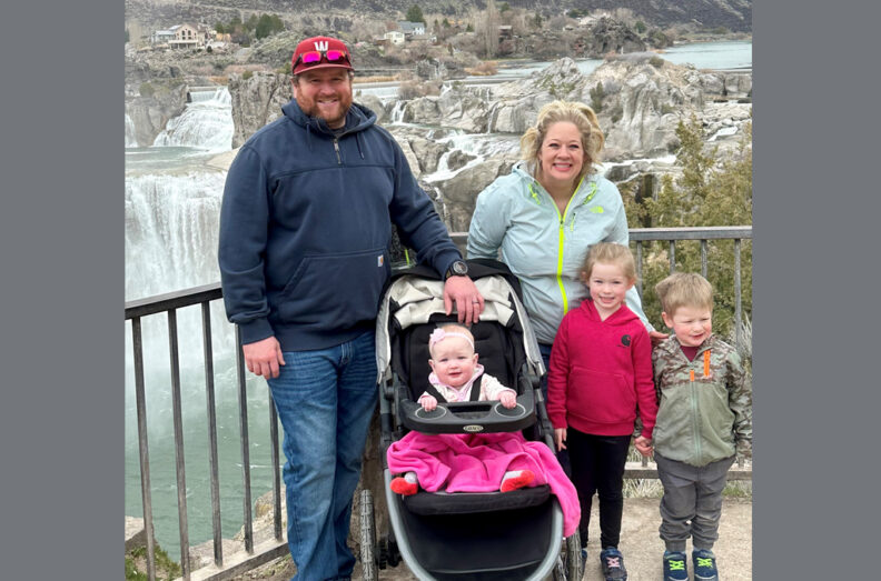 Dirk with his family, with waterfalls behind them in the distance.