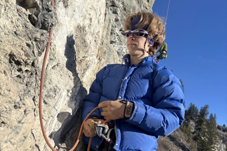 Nathan Crumby is shown rock climbing.