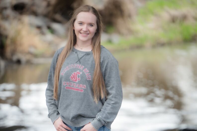 Matteya Proctor poses next to a stream.