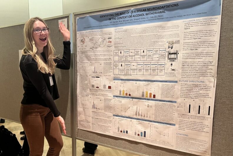 Aspen Harder poses with a poster she presented at SURCA.