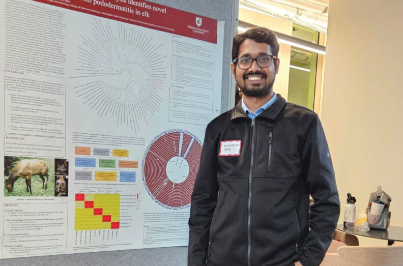 Sushanta standing next to his research poster.