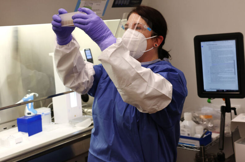 A medical technologist in a molecular diagnostic lab extracts DNA from milk samples for testing.