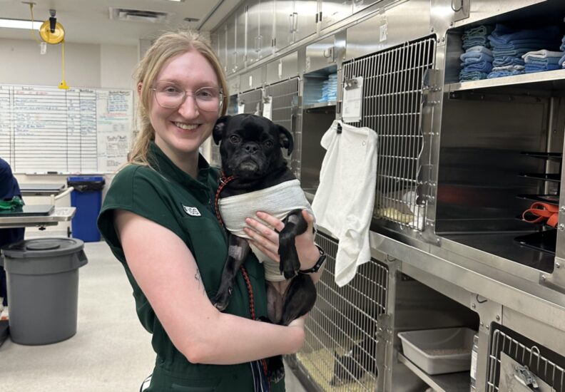 Brittany White poses with a dog.