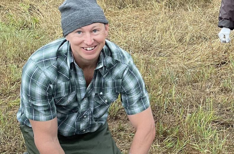 Charlie, down on his knees, gathering samples for research.
