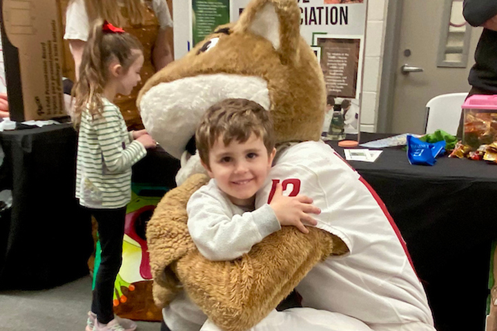 Young boy getting a big hug from Butch.