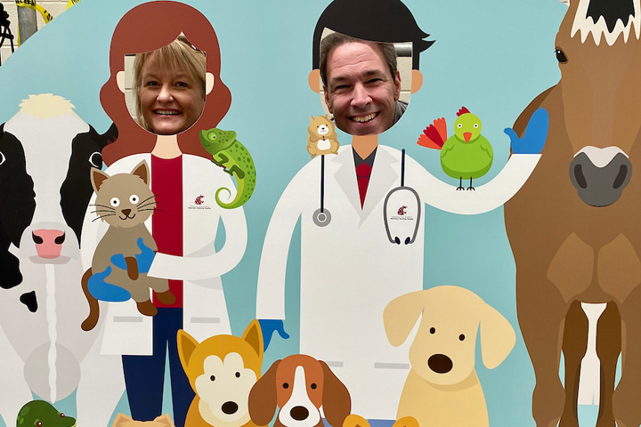 Two adults having a good time in the photo booth.