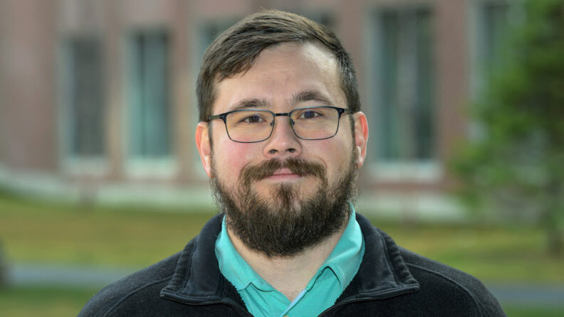 Blake standing outside the building he works in. 