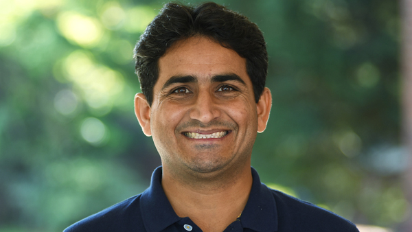 Dr. Waqas outside on a summer day.