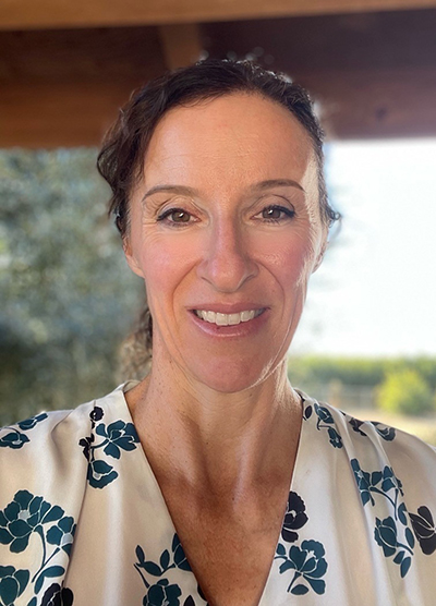 Photo of Dr. Mongini, outside under a covered patio.