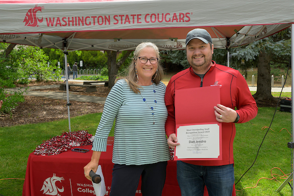Dan standing next to Dean Dori, and holding his certificate.