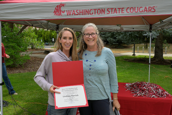 Lindsay standing with Dean Dori for a photo.