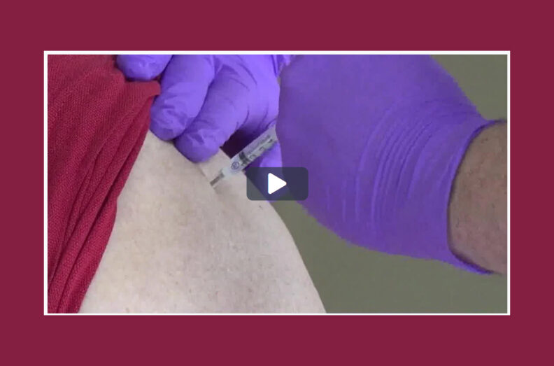 Screen grab from video. Close up of shot being administered in someone's upper arm.
