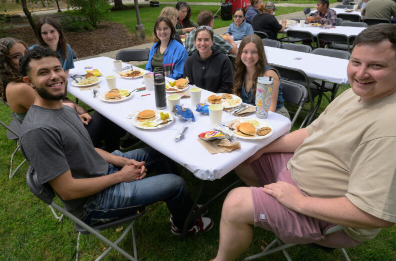 People seated around a table with their plates full.