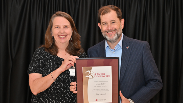 Lynne receiving her certificate from System Provost and Executive Vice President T. Chris Riley-Tillman.
