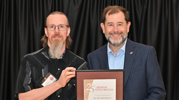 Eric receiving his certificate from System Provost and Executive Vice President T. Chris Riley-Tillman.