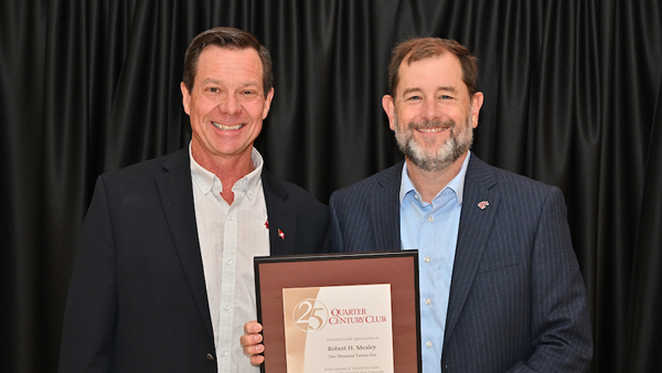 Dr. Robert Mealey receiving his certificate from System Provost and Executive Vice President T. Chris Riley-Tillman.