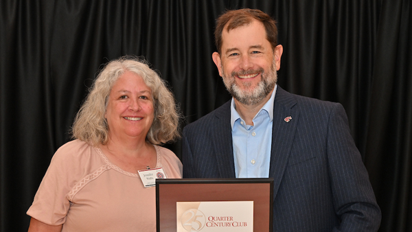 Dr. Watts receiving her certificate from System Provost and Executive Vice President T. Chris Riley-Tillman.