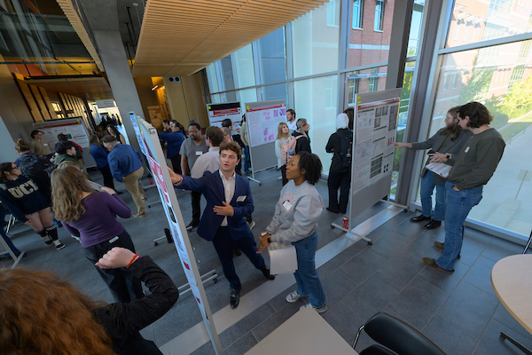 Students looking at research posters.