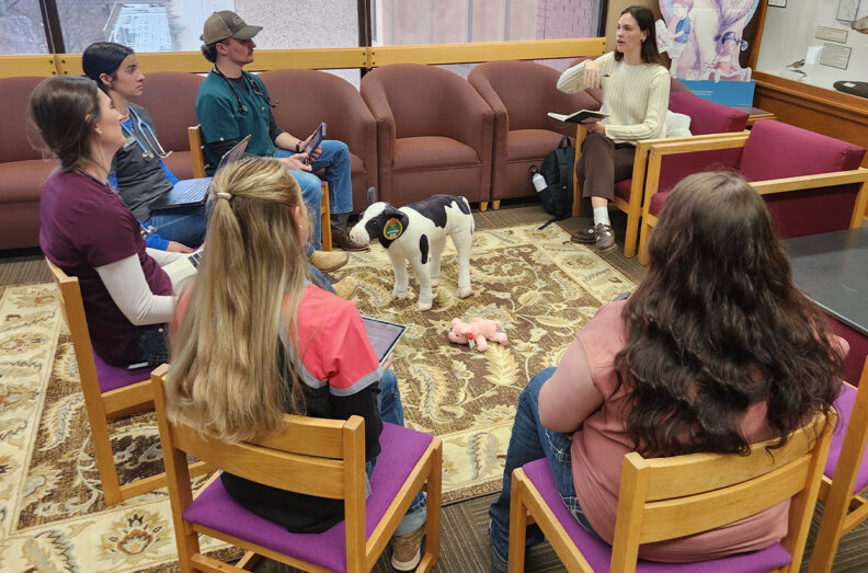 Second-year veterinary students answer questions as Lauren Rendahl, a journalism student, interviews them about their infectious disease case at the WSU Diagnostic Challenge last fall in the Owen Science Library on the WSU Pullman campus.