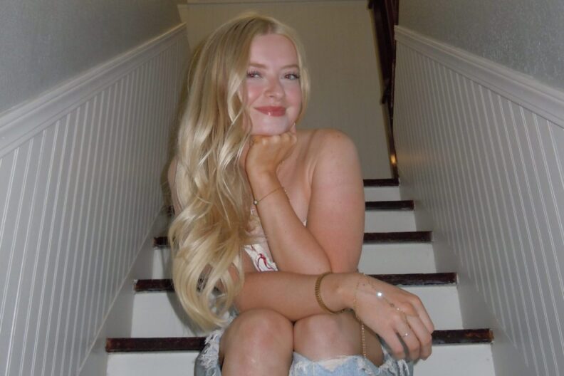 Lizzy Hedges poses on a stairs.