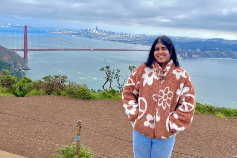 Danki Dalvi poses near a bridge.